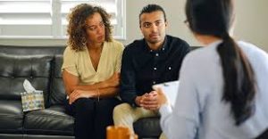 men and women sitting in front of therapist